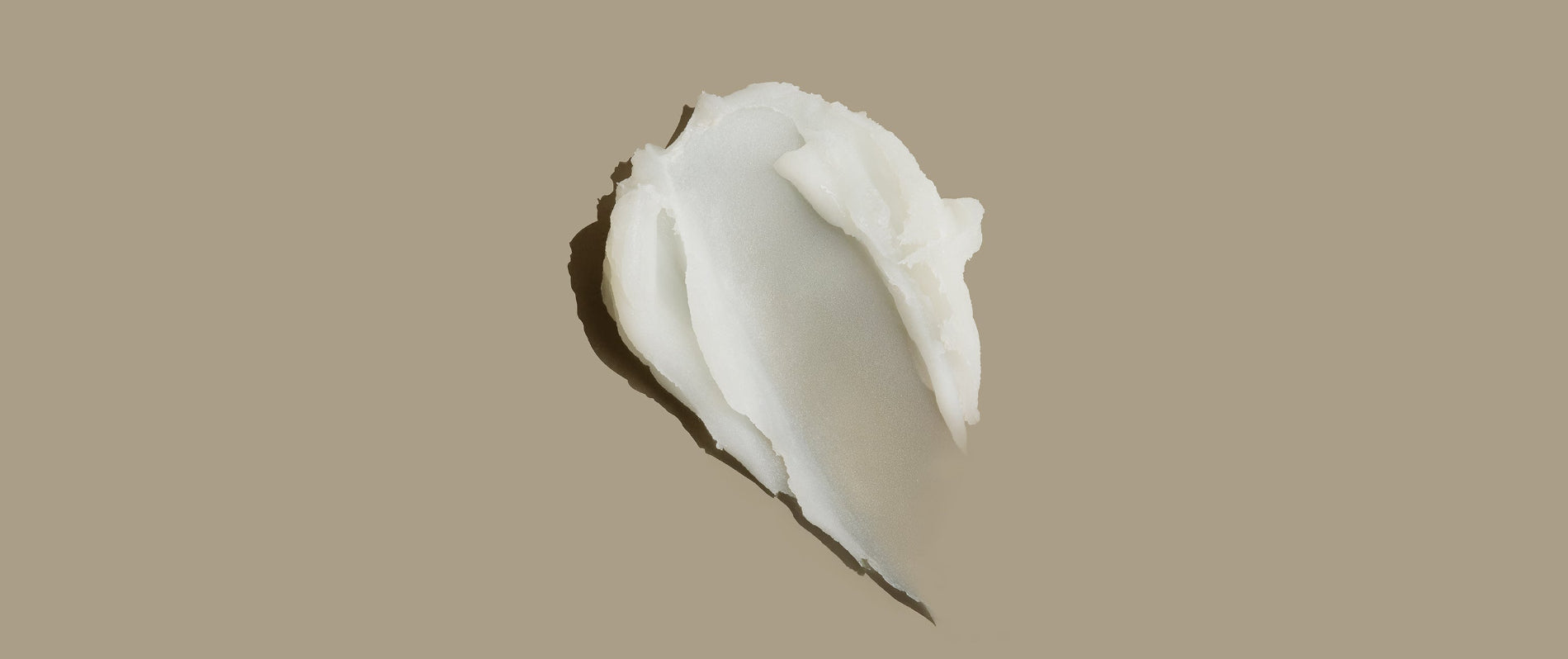 Close-up of the AS I AM Rosemary Wax Stick texture, showing a smooth, creamy balm with a semi-matte finish, designed for sleek styling and frizz control.