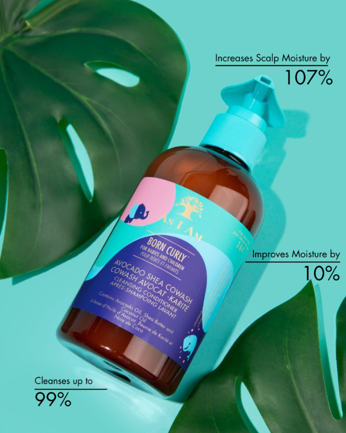 Bottle of hair care product with green leaves on a light blue background
