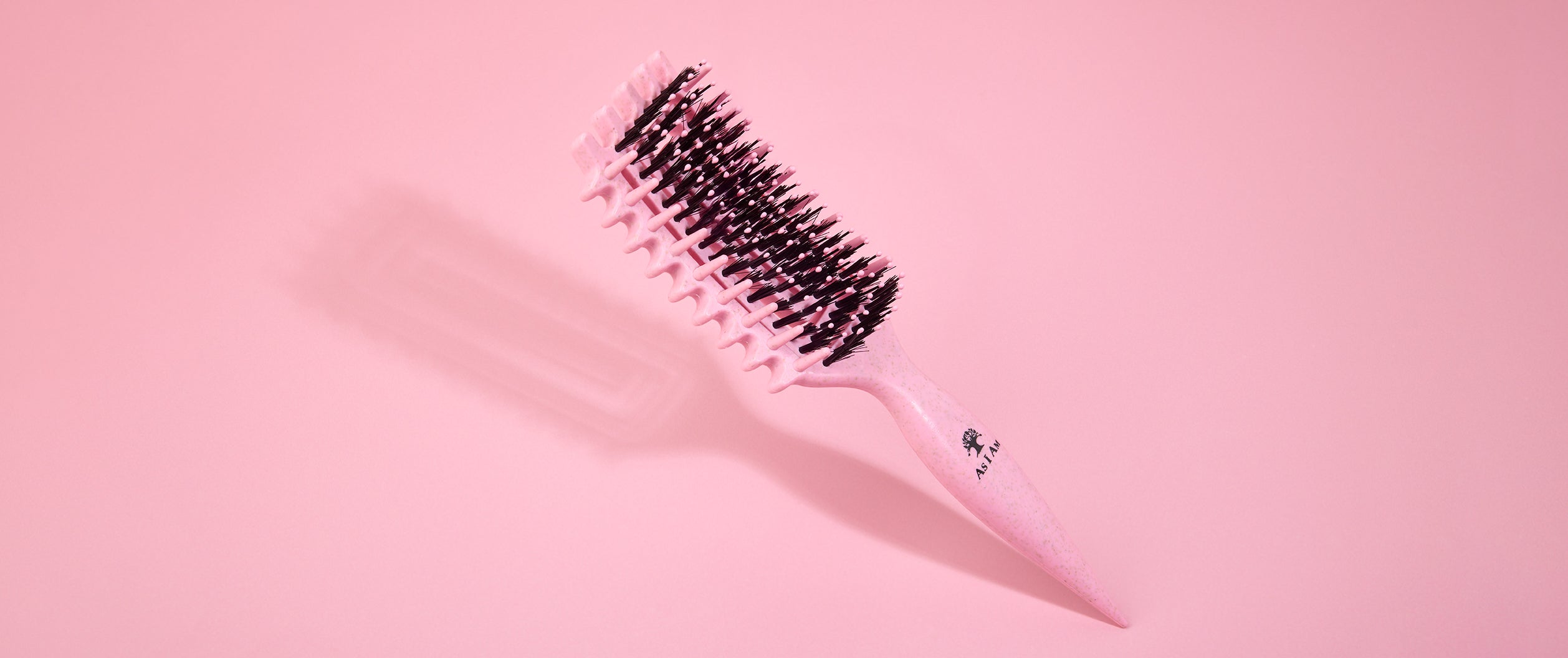 Hairbrush on a pink background