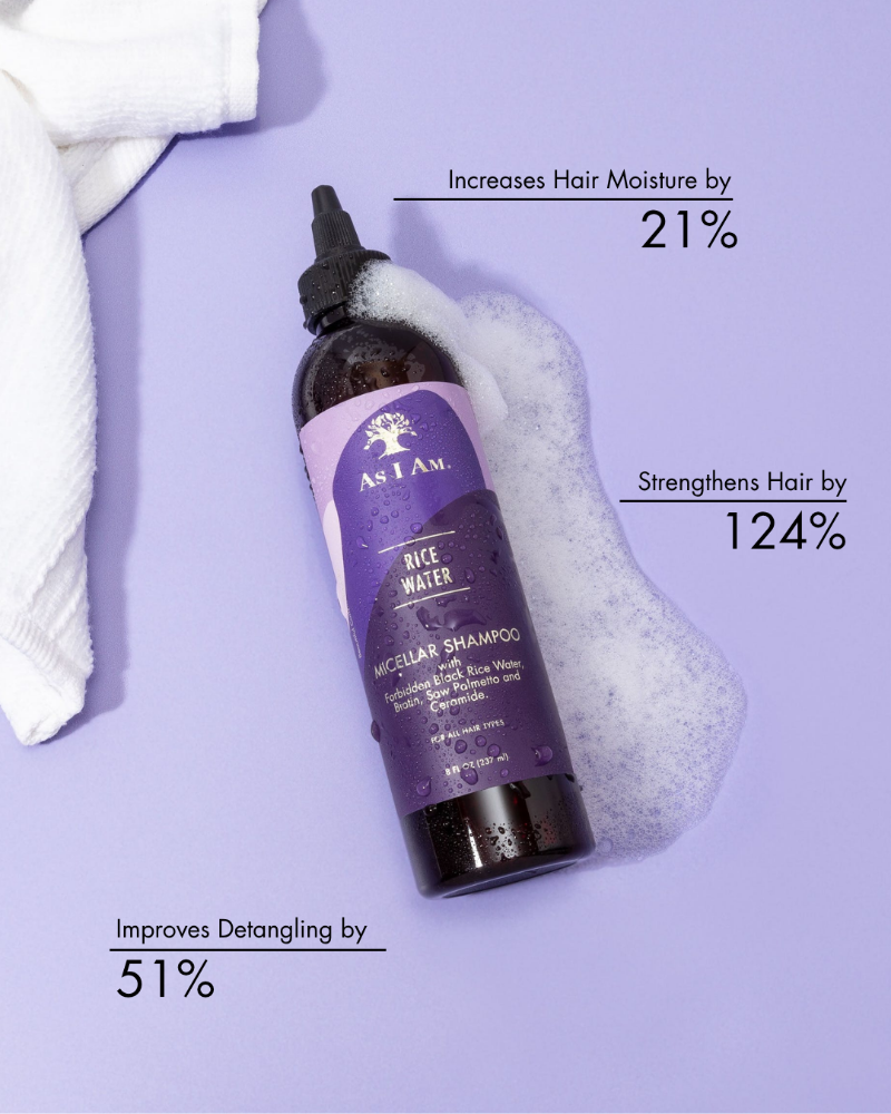 Bottle of As I Am Rice Water Micellar Shampoo with text on benefits on a purple background