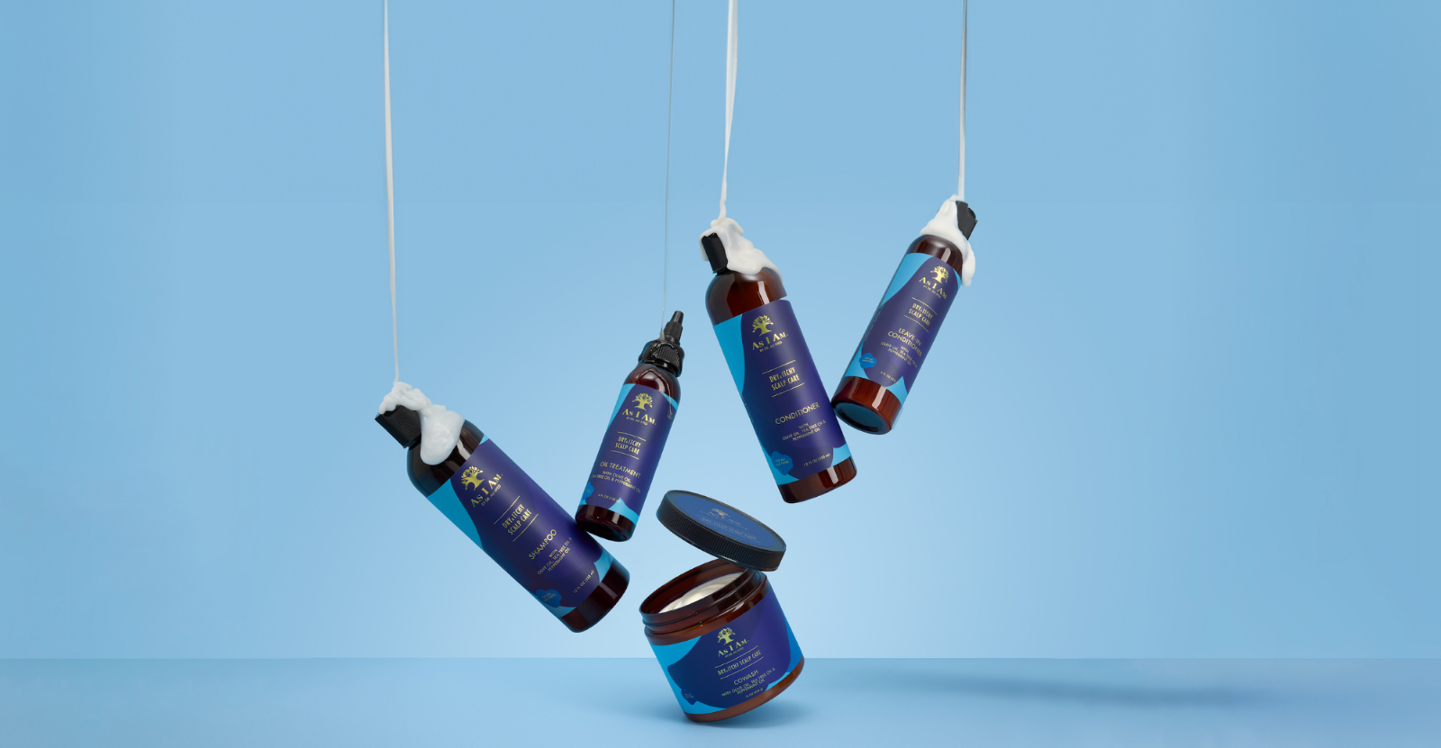 Set of skincare products with blue packaging hanging against a light blue background
