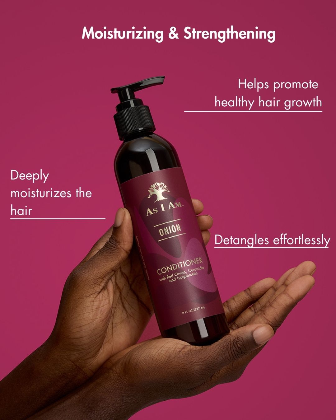 Hand holding a bottle of 'As I Am' conditioner with text on a pink background