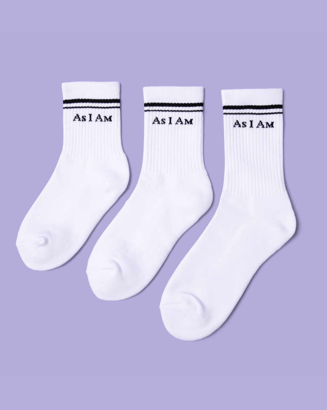 Three white socks with 'As I Am' text on a purple background