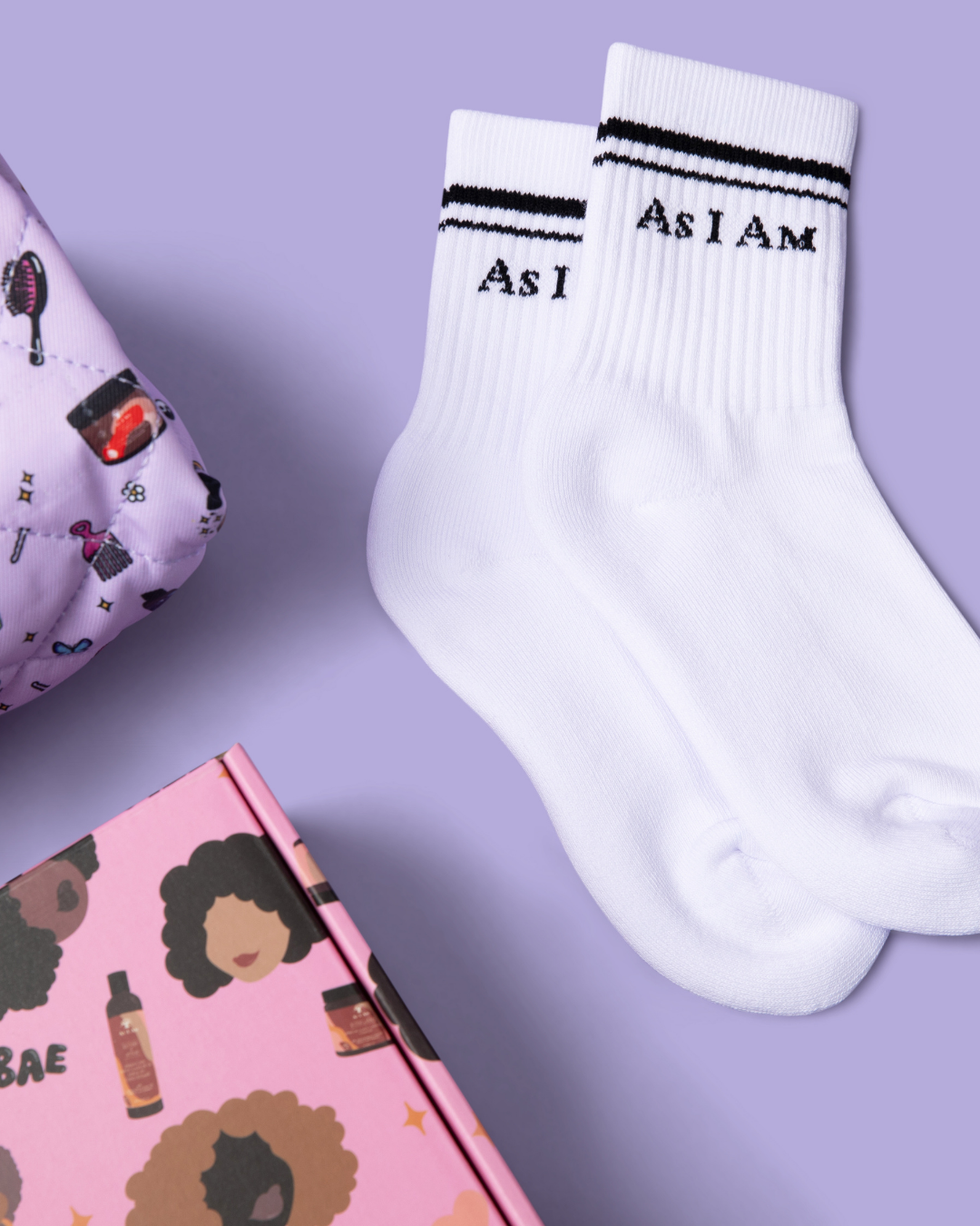 White socks with 'As I Am' text on a purple background