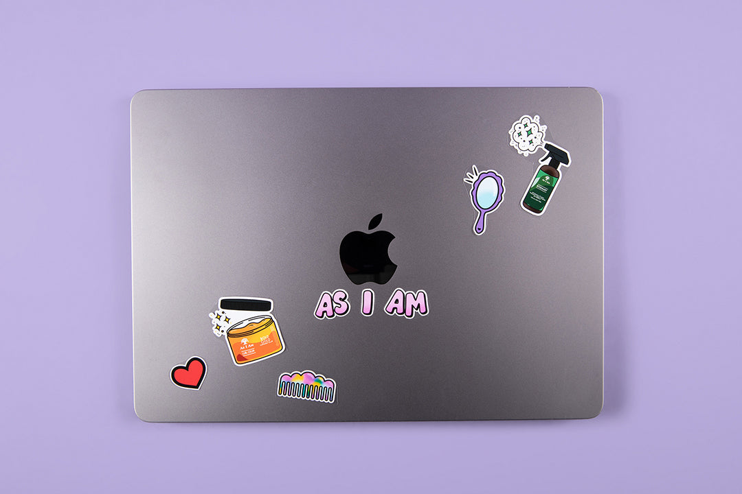 As I Am branded stickers on a laptop — landscape image showcasing bold, playful sticker designs that reflect curl pride and individuality, adding personality to tech accessories.