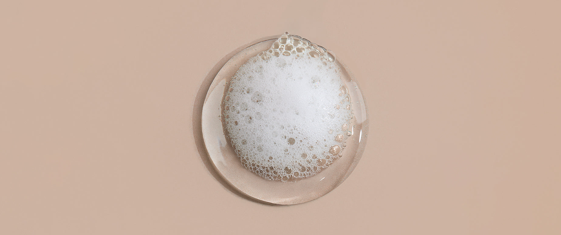 Foamy soap bar on a beige background