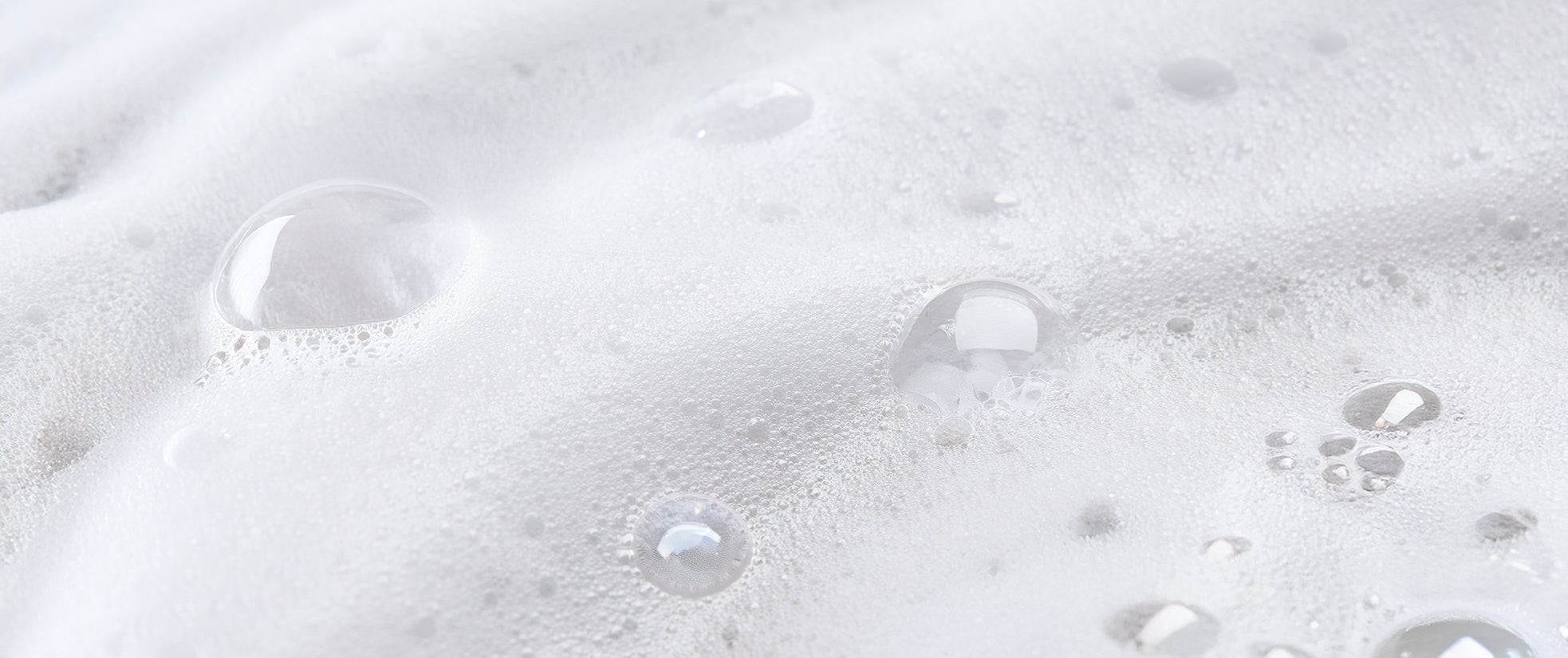 Close-up of soapy water with bubbles on a white background