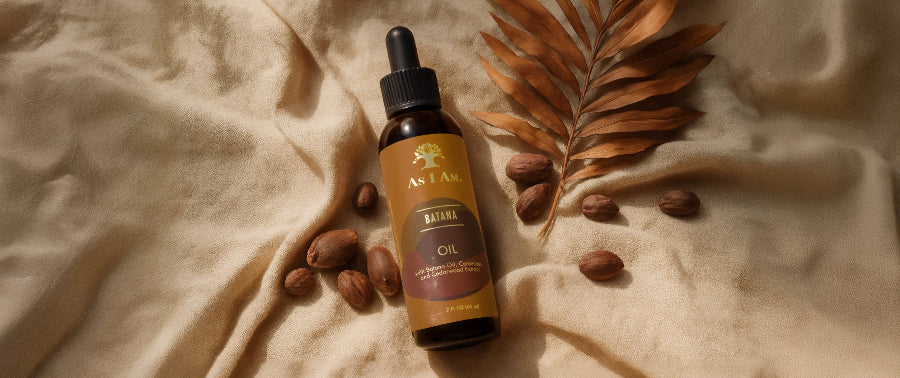 Bottle of Anjali Bhringa Oil with seeds and leaves on a textured beige fabric background