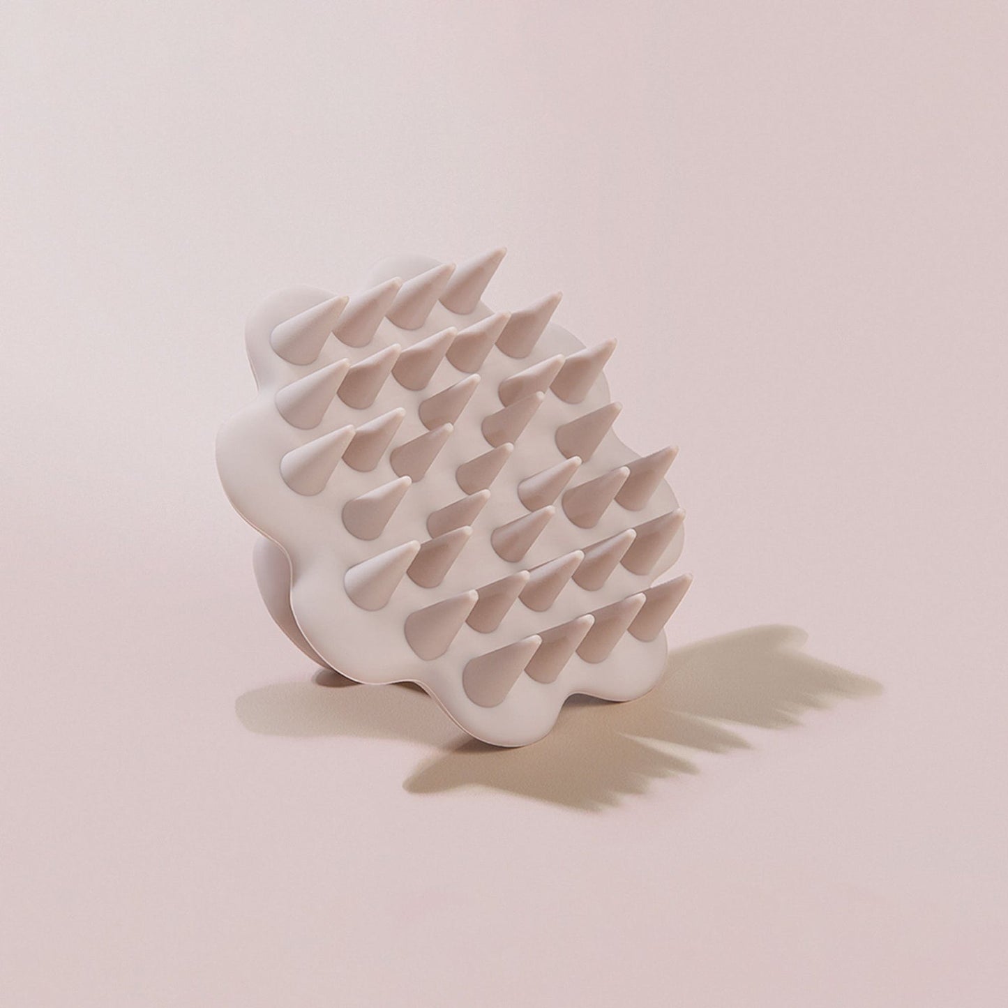 Beige scalp brush on beige background plain