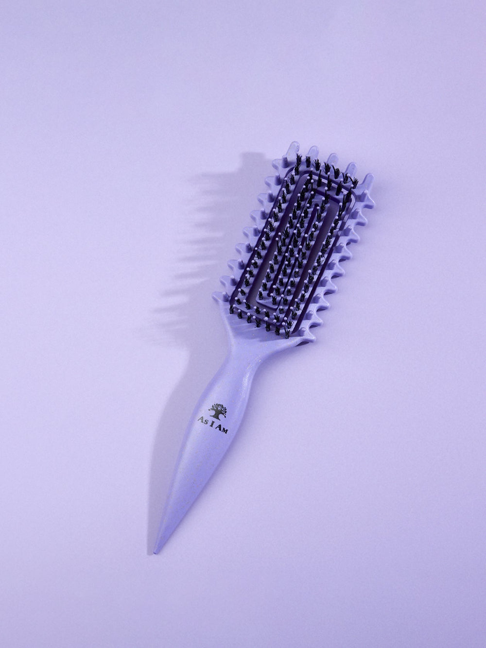 Purple hairbrush with bristle head on a light purple background
