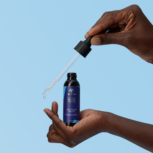 Hand holding a bottle of 'Itch Relief Drops' with a dropper against a blue background