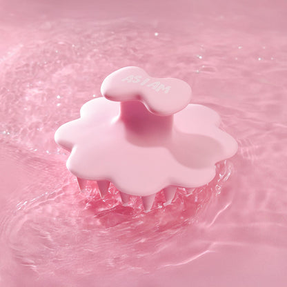 Pink scalp brush on a pink water background