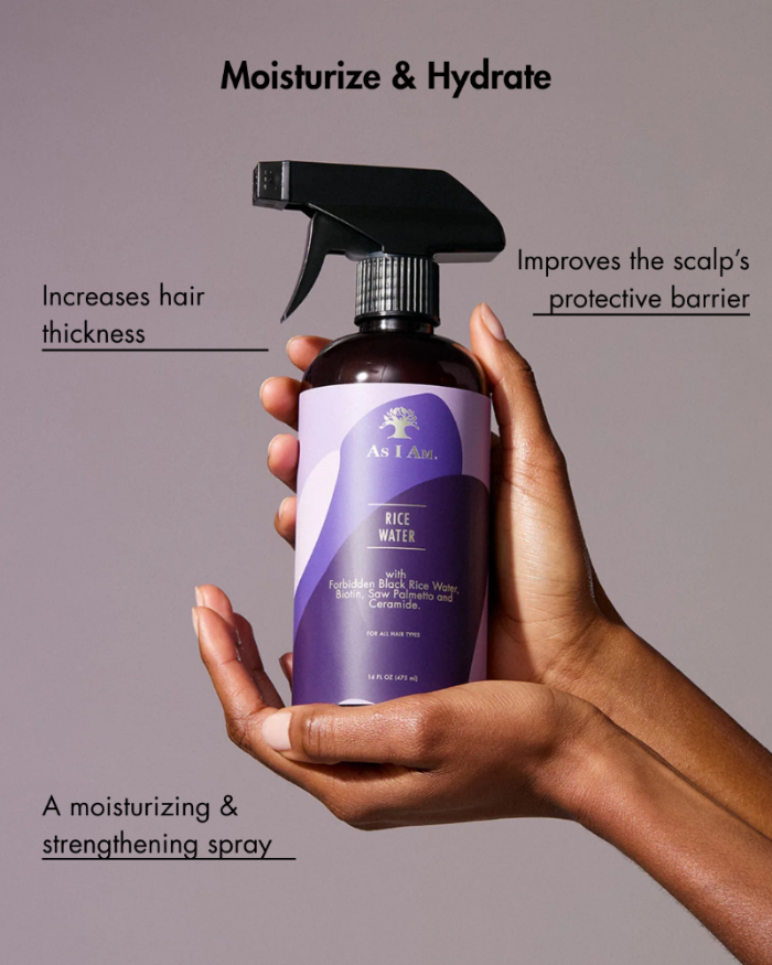 Hand holding a bottle of 'Anafan' rice water spray with text on a gray background