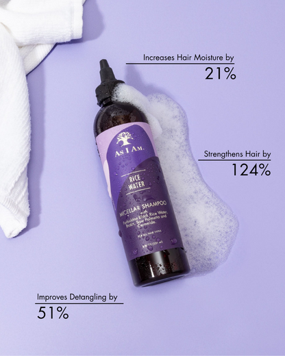 Bottle of As I Am Rice Water Micellar Shampoo with text on benefits on a purple background