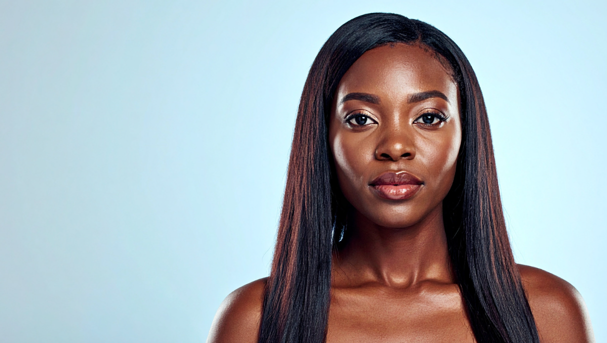 Woman with straight black hair against a light blue background