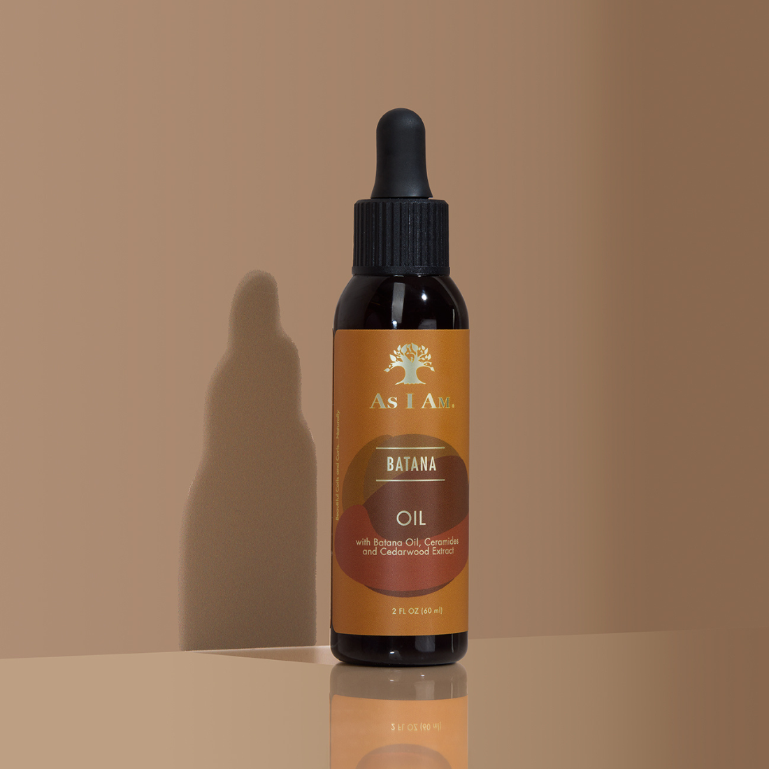 Bottle of As I Am batana Oil on a beige background