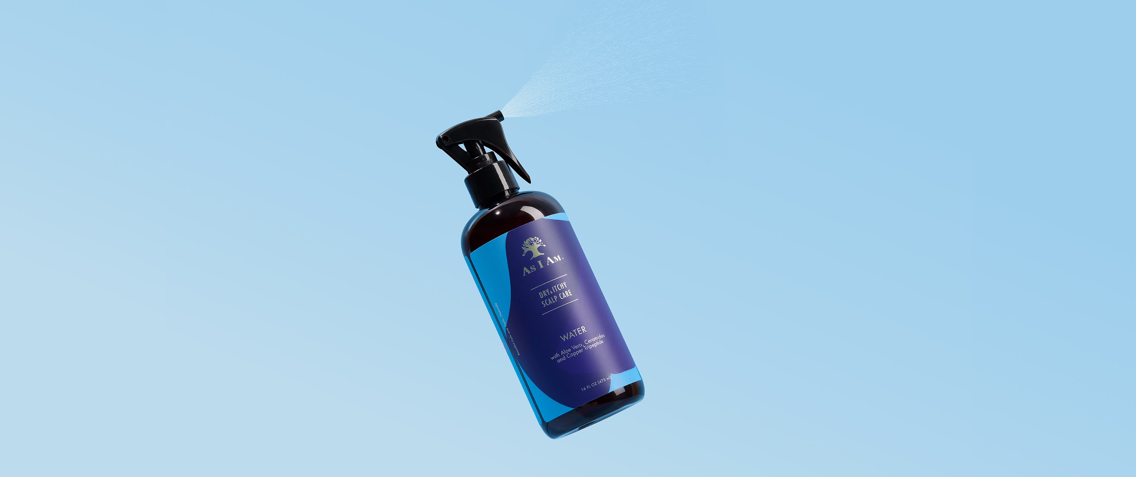 As I Am Dry & Itchy Scalp Care Spray bottle against a light blue background