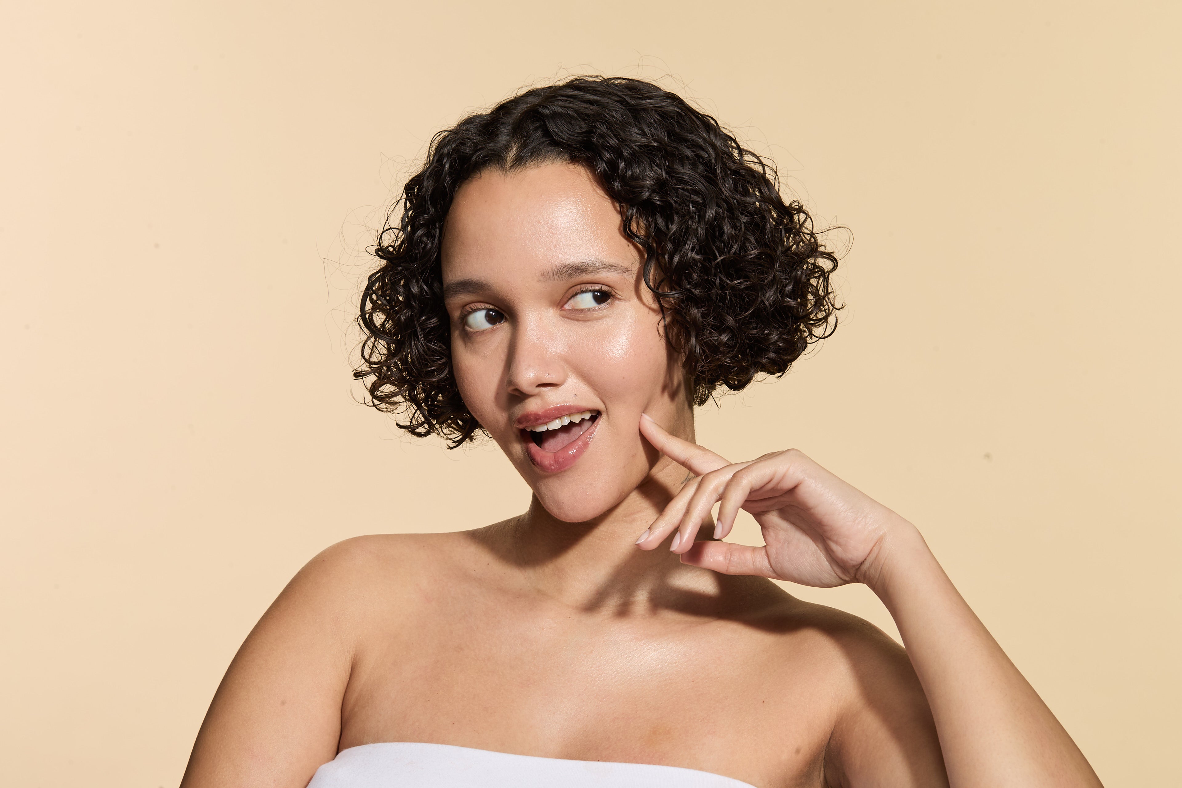 Woman posing with As I Am skincare applied. 