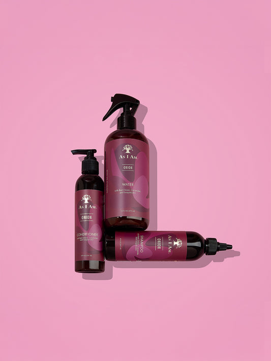 Ensemble de produits capillaires avec marque visible sur fond rose