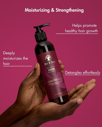 Hand holding a bottle of 'As I Am' conditioner with text on a pink background