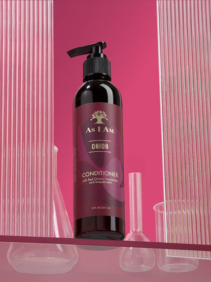 Bottle of 'As I Am Onion' conditioner with a pump on a pink background