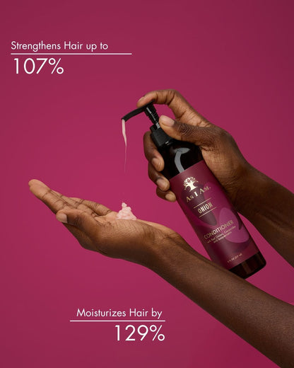 Hand holding a bottle of hair care product with text on a pink background