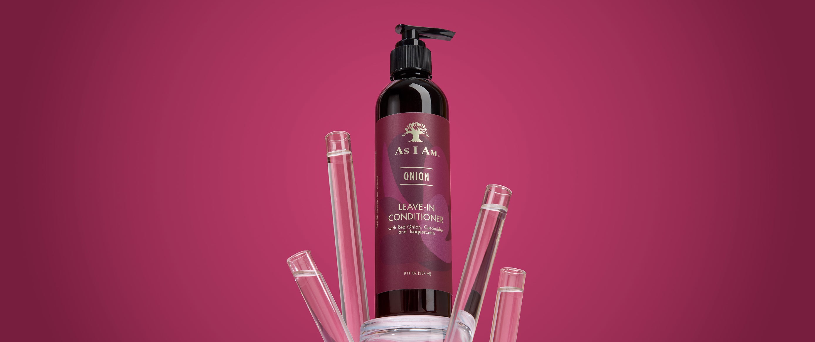 A bottle of as i am Leave-In Conditioner on a pink background