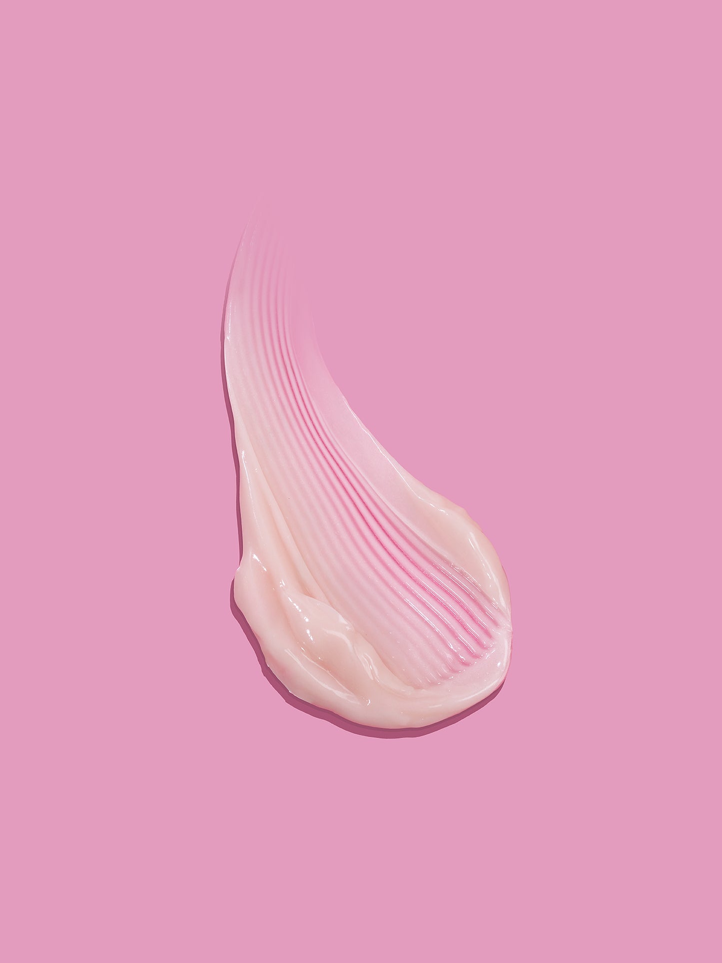 Pink cream swatch on a pink background