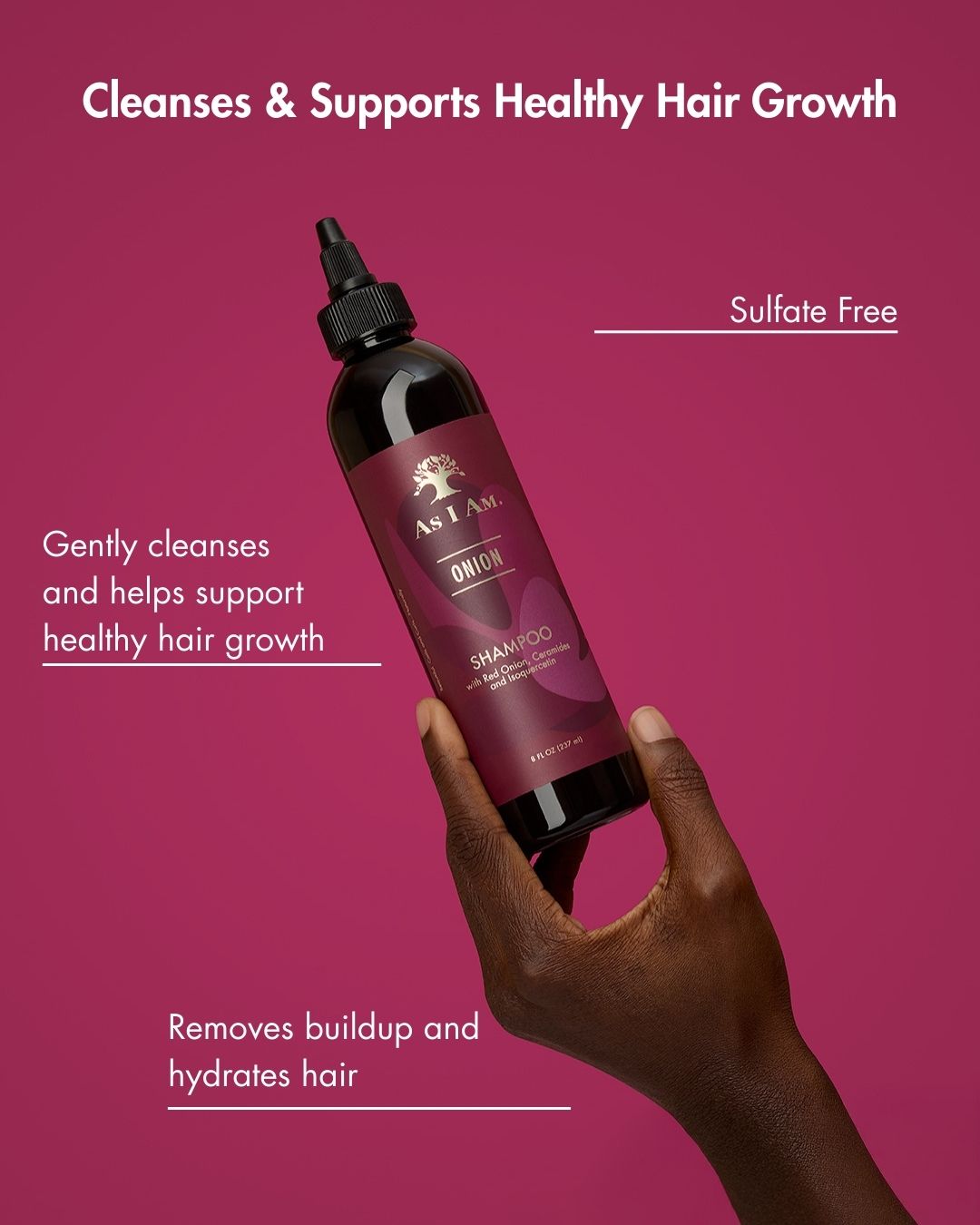 Bottle of shampoo held by a hand with text about hair care on a pink background