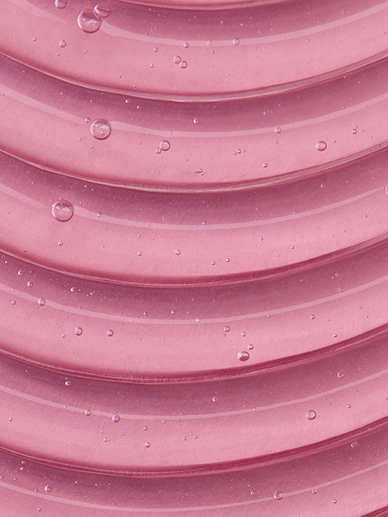 Close-up of pink textured surface with water droplets