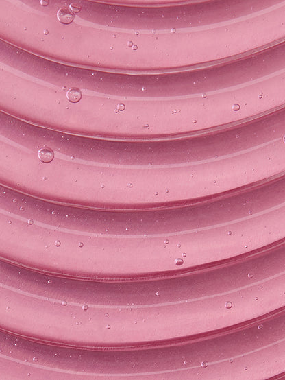 Close-up of pink textured surface with water droplets