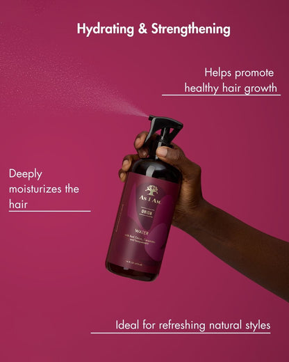 Hand holding a purple bottle with text about hair care on a pink background