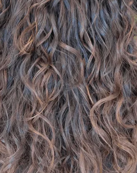 Close-up of wavy hair with brown and black coloration