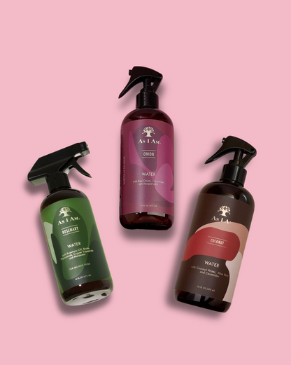 Three bottles of As I Am hair care products on a pink background